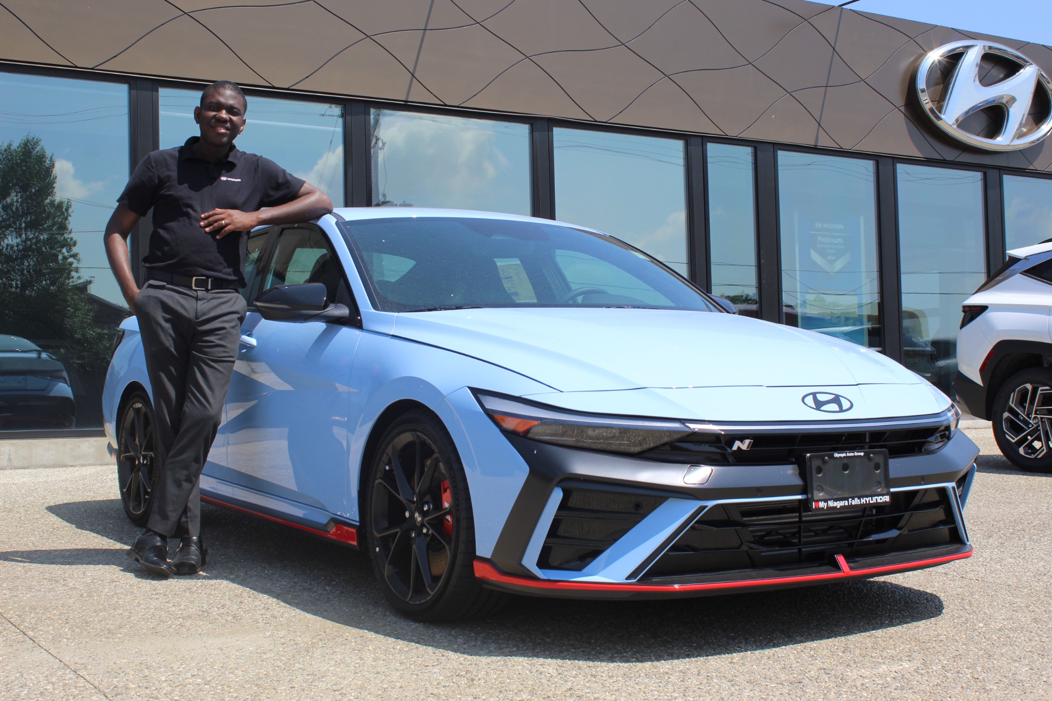 Ife Solomon beside a blue Hyundai Elantra N